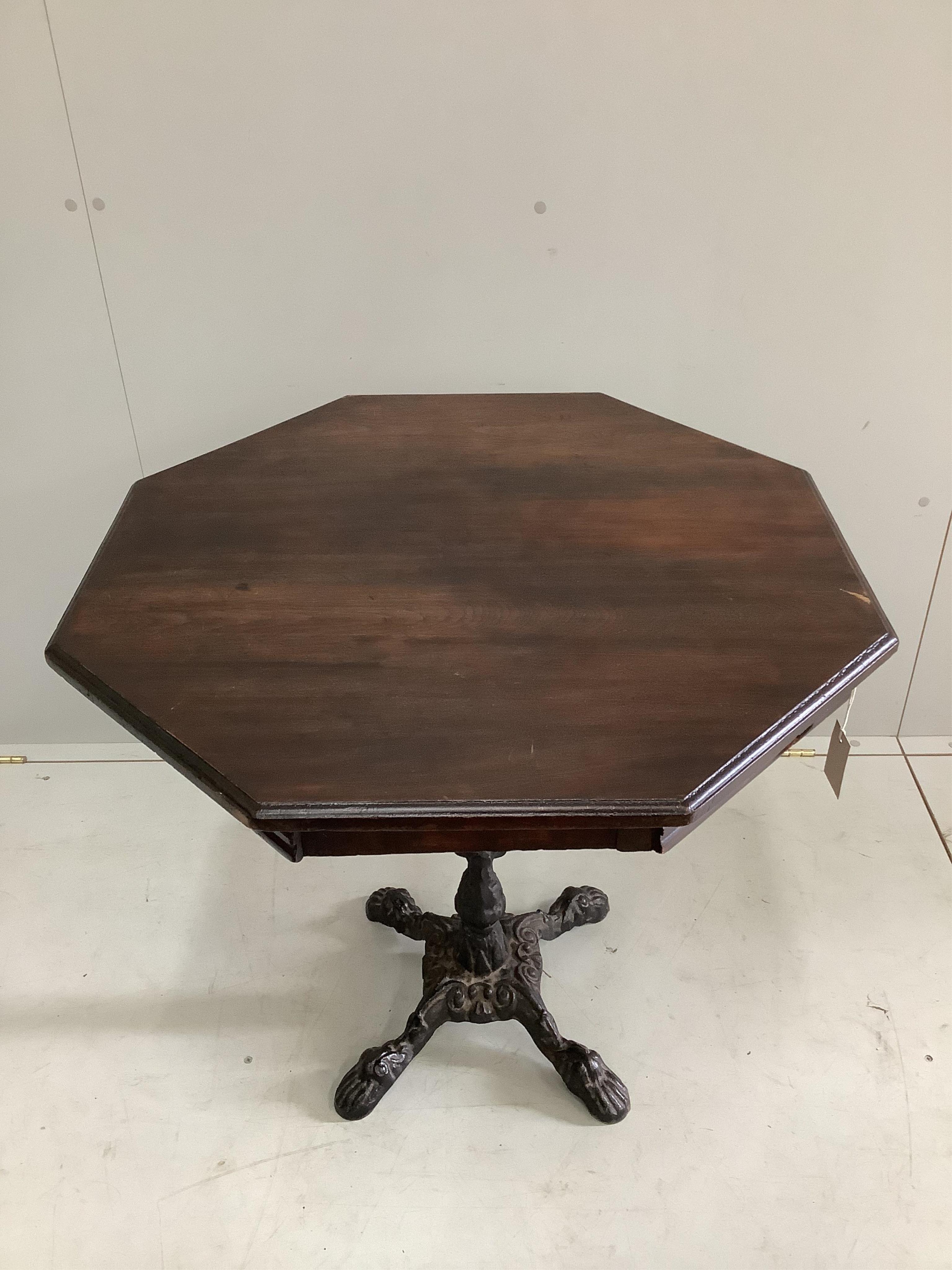 A late Victorian octagonal mahogany and cast iron centre table, width 75cm, height 72cm. Condition - fair